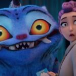 Rumi looks surprised at something behind her next to a giant tiger.