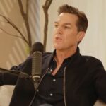 Andrew Wilson talks on a podcast.