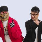 Two guys doing devil horns.