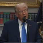 Trump talking into a microphone