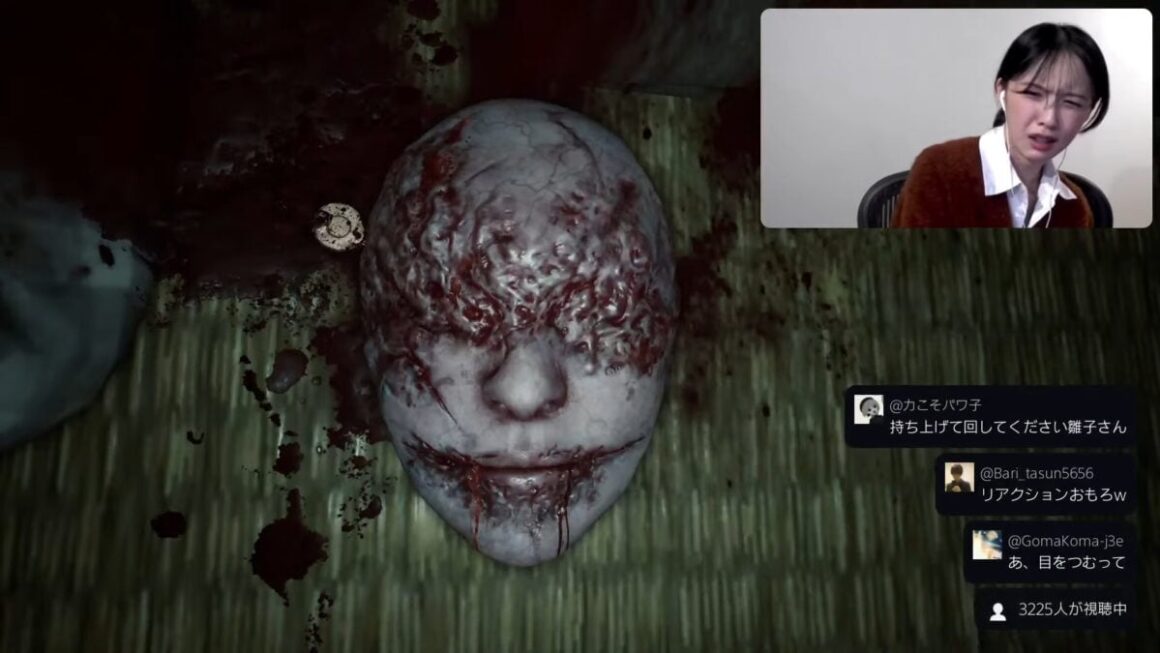 Konatsu Kato makes a face of disgust while looking at a bloody mask in Silent Hill f.