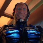 A creepy robot has a human face.