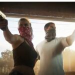 Two people rob a store with guns.