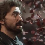 A battle-weary warrior looks at falling petals.