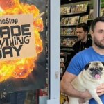 A man carries a Pug out of GameStop.