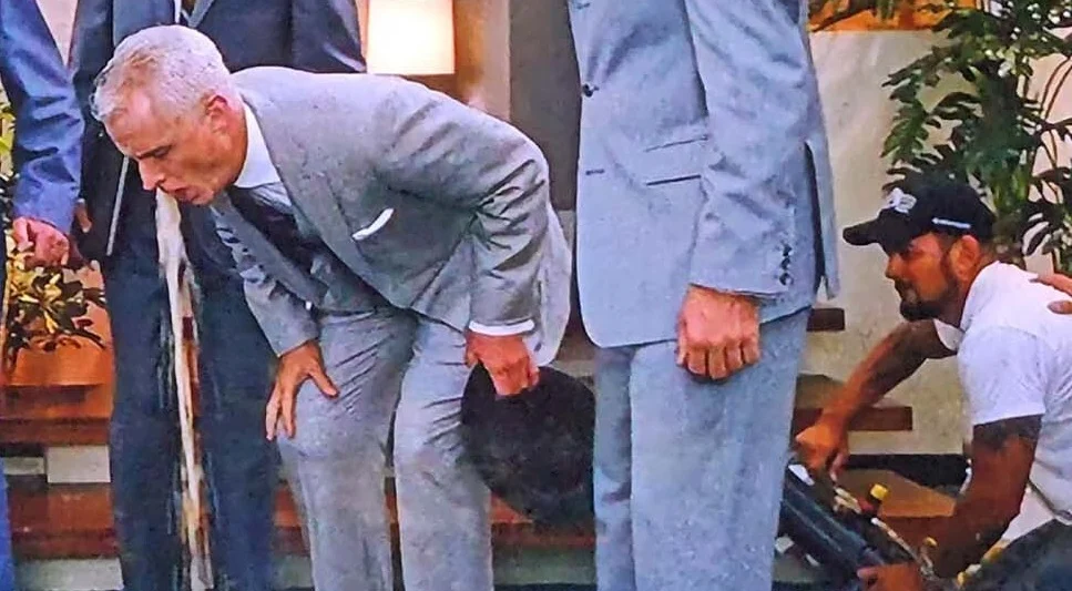 Roger Sterling pukes from a machine that appears off stage.