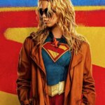 Supergirl appears in front of a big S.