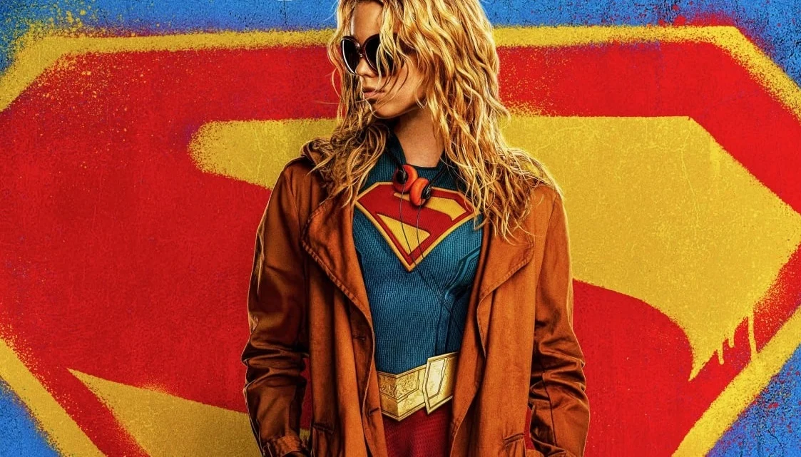 Supergirl appears in front of a big S.