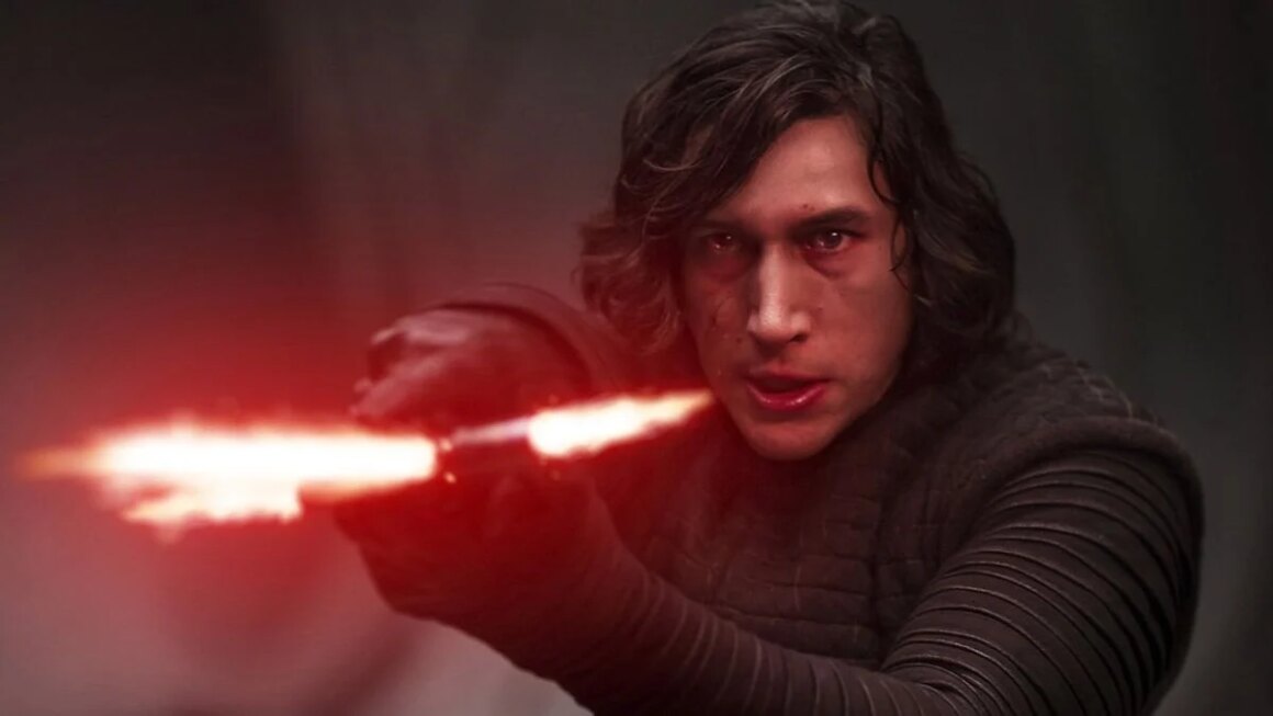 Kylo Ren holds up a red light saber.