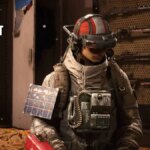 A raider wears a mask in her apartment.